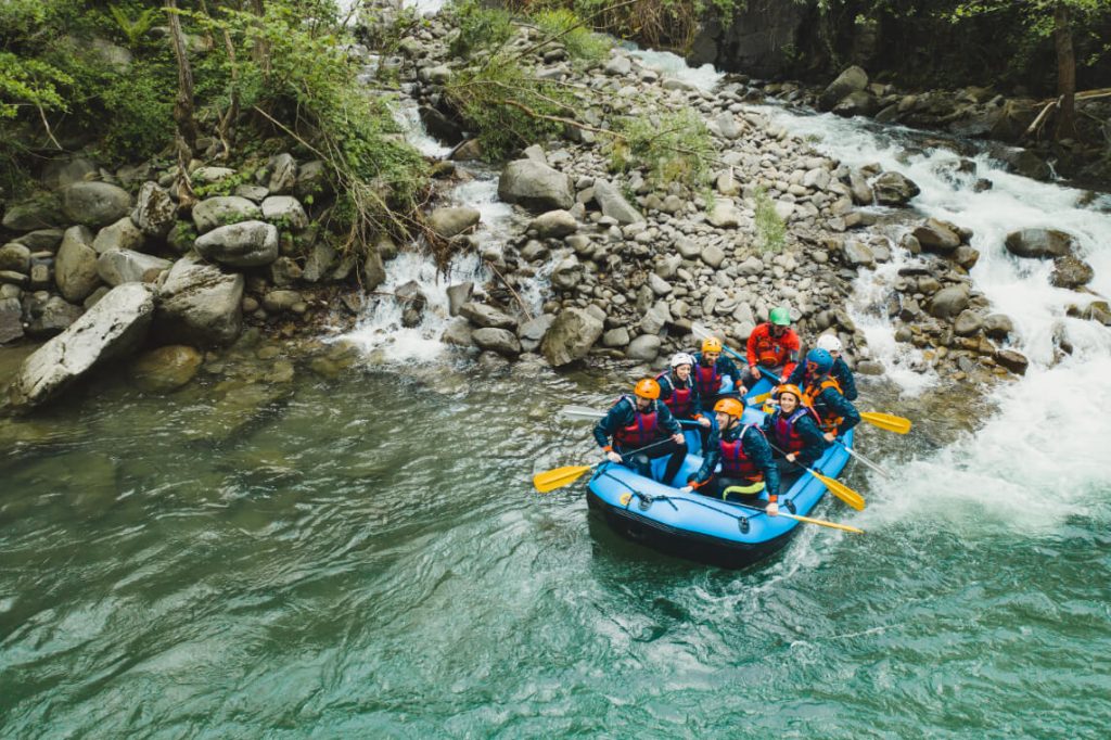 group-of-people-rafting-in-rubber-dinghy-on-a-river